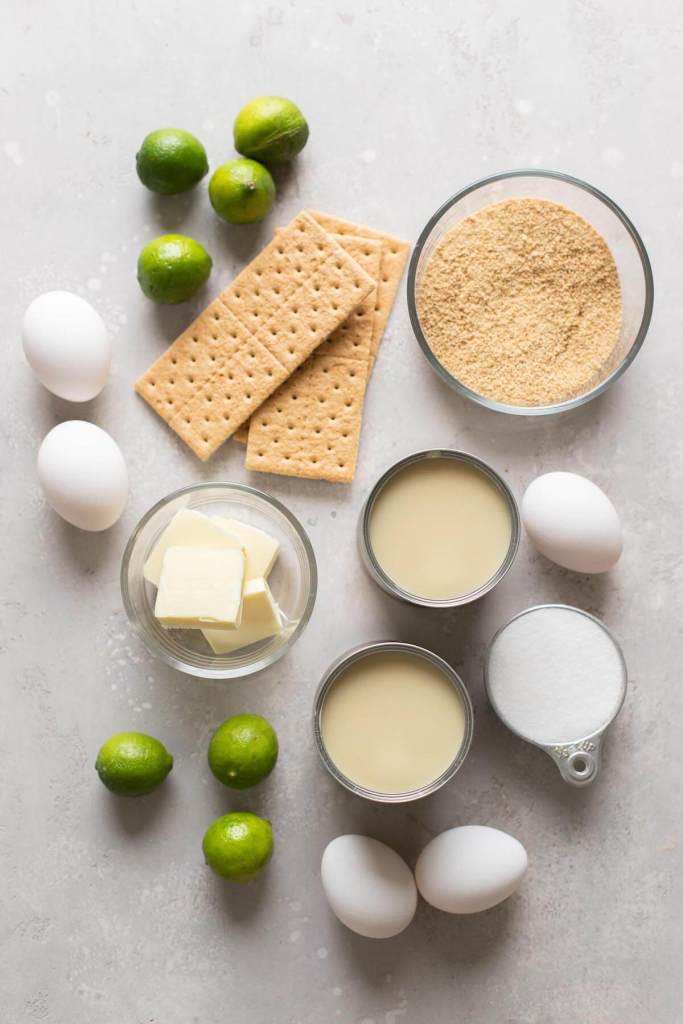 An overhead view of the ingredients needed to make homemade key lime pie. 