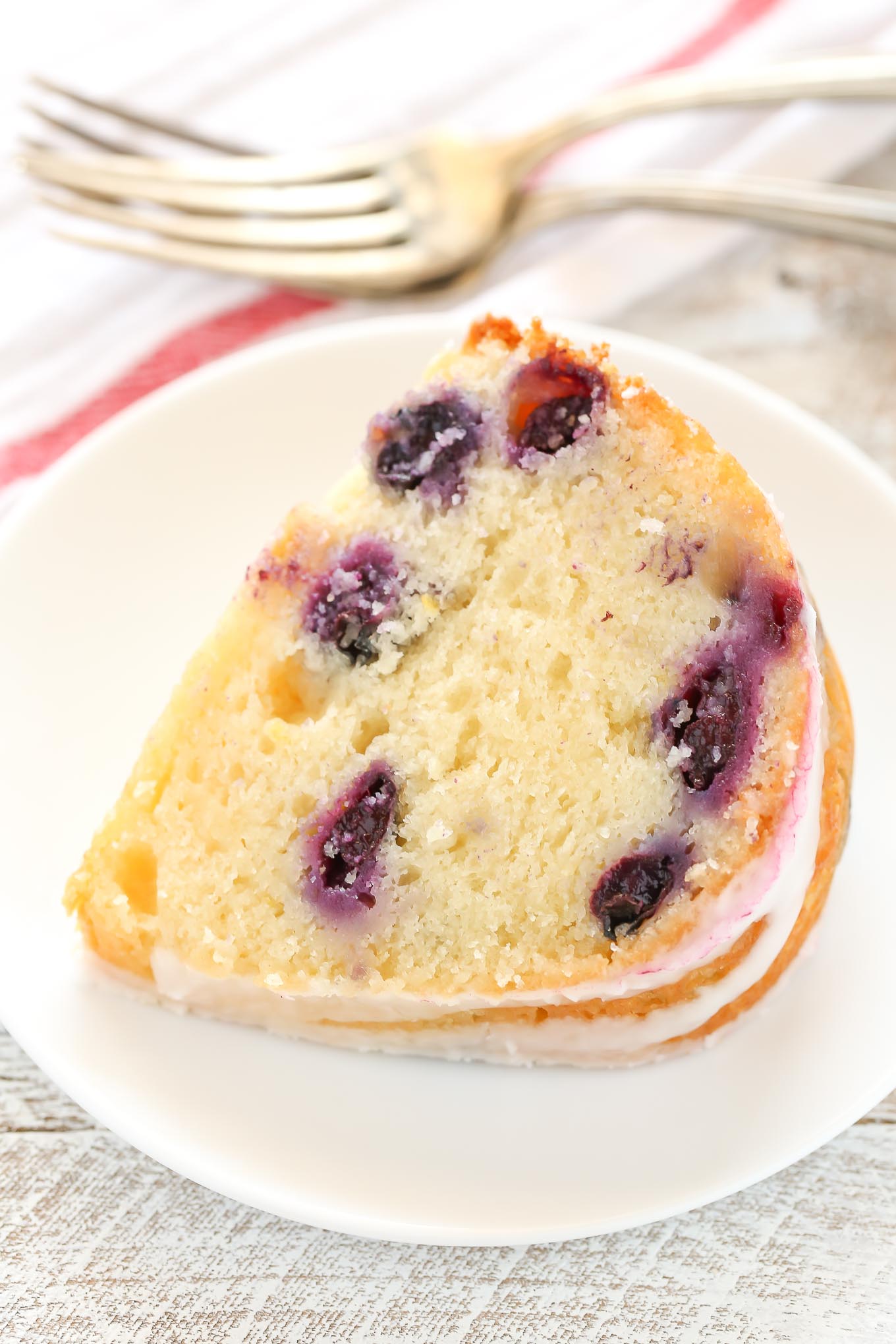 A moist lemon bundt cake filled with fresh blueberries and topped with a sweet lemon glaze. This Lemon Blueberry Bundt Cake is a perfect dessert for lemon lovers!