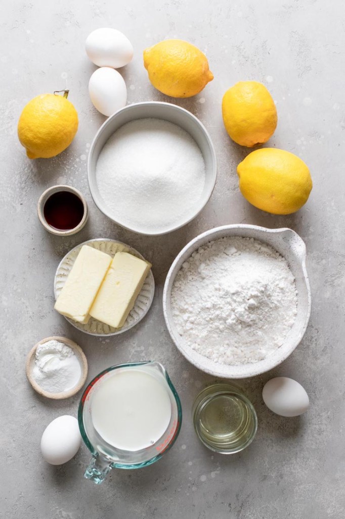 An overhead view of the ingredients needed to make a lemon cake from scratch. 