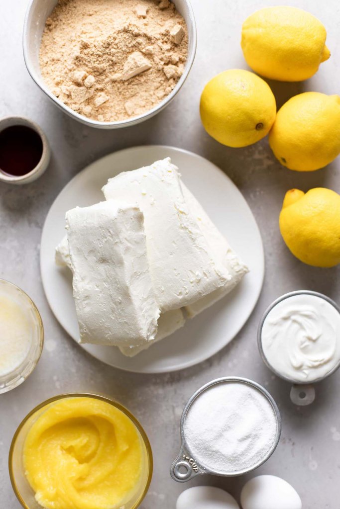 An overhead view of the ingredients needed to make a lemon curd cheesecake. 