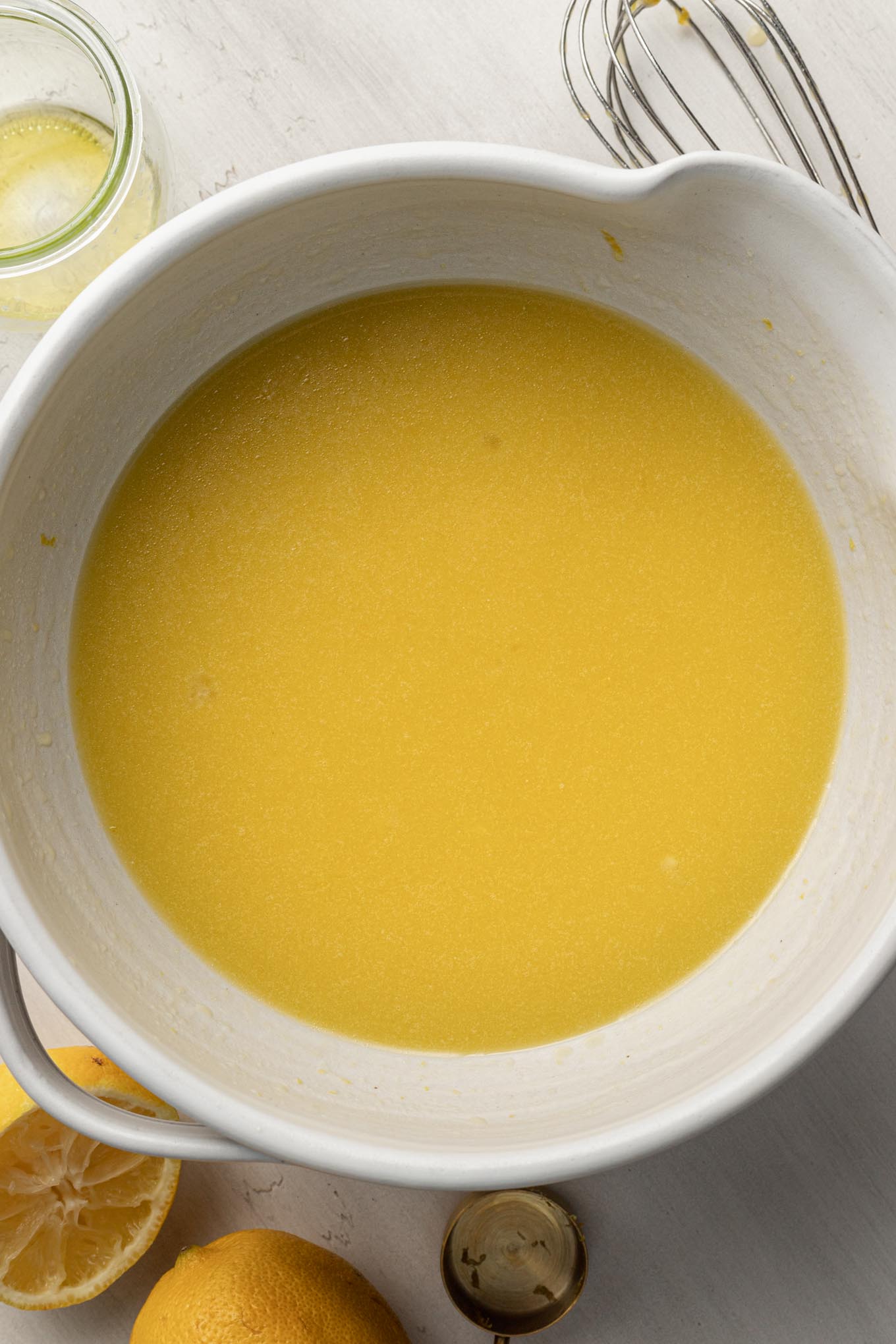 An overhead view of wet ingredients in a mixing bowl.