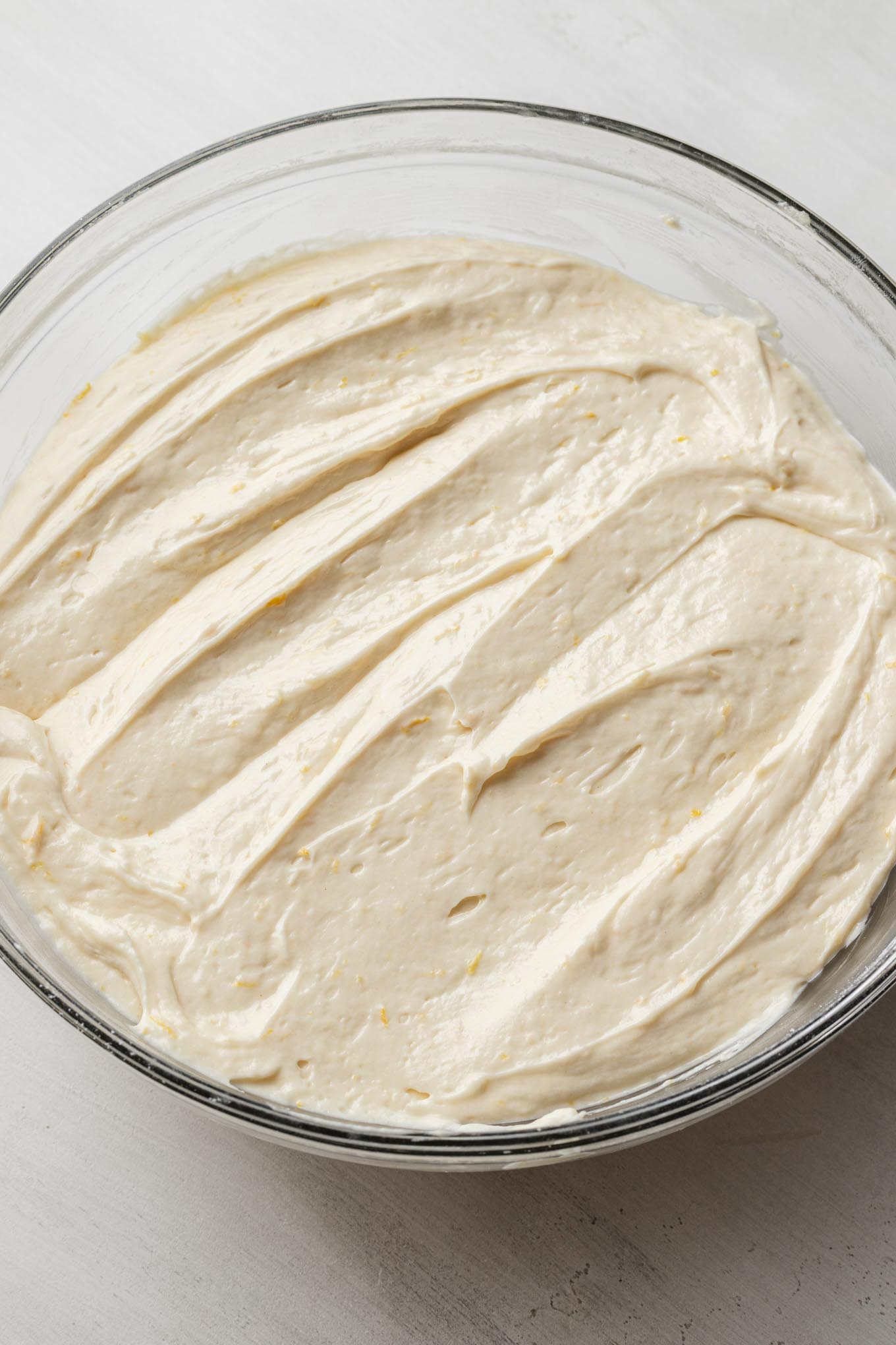 Lemon pound cake batter in a glass mixing bowl.