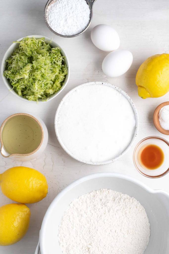 An overhead view of the ingredients needed to make zucchini bread with lemon. 