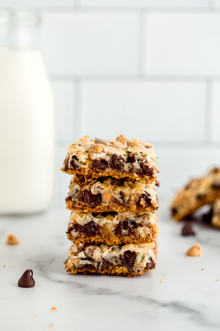 A stack of magic cookie bars sitting on a marble surface.