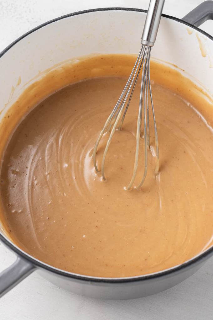 Caramel filling in a saucepan, with a whisk.