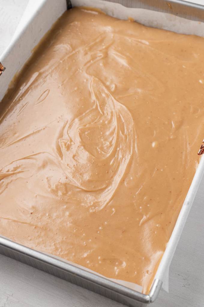 Caramel filling poured into a 9x13-inch baking dish.