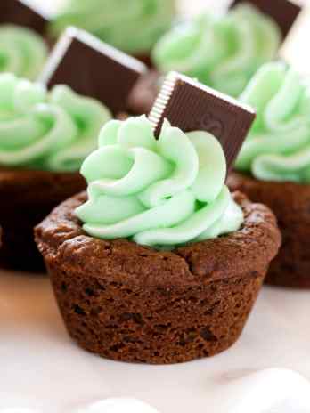 Chocolate cookie cups filled with an easy mint frosting and topped with an andes mint. These Mint Chocolate Cookie Cups are a perfect treat for St. Patrick's Day or mint chocolate lovers!