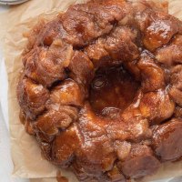 An overhead view of monkey bread on a piece of brown parchment paper.