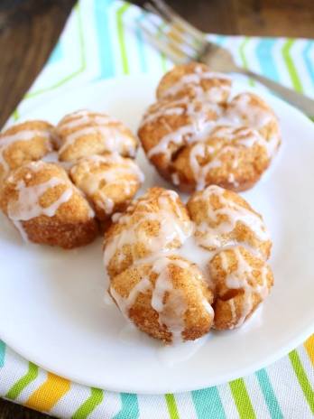 Three Monkey Bread Muffins on a white plate.