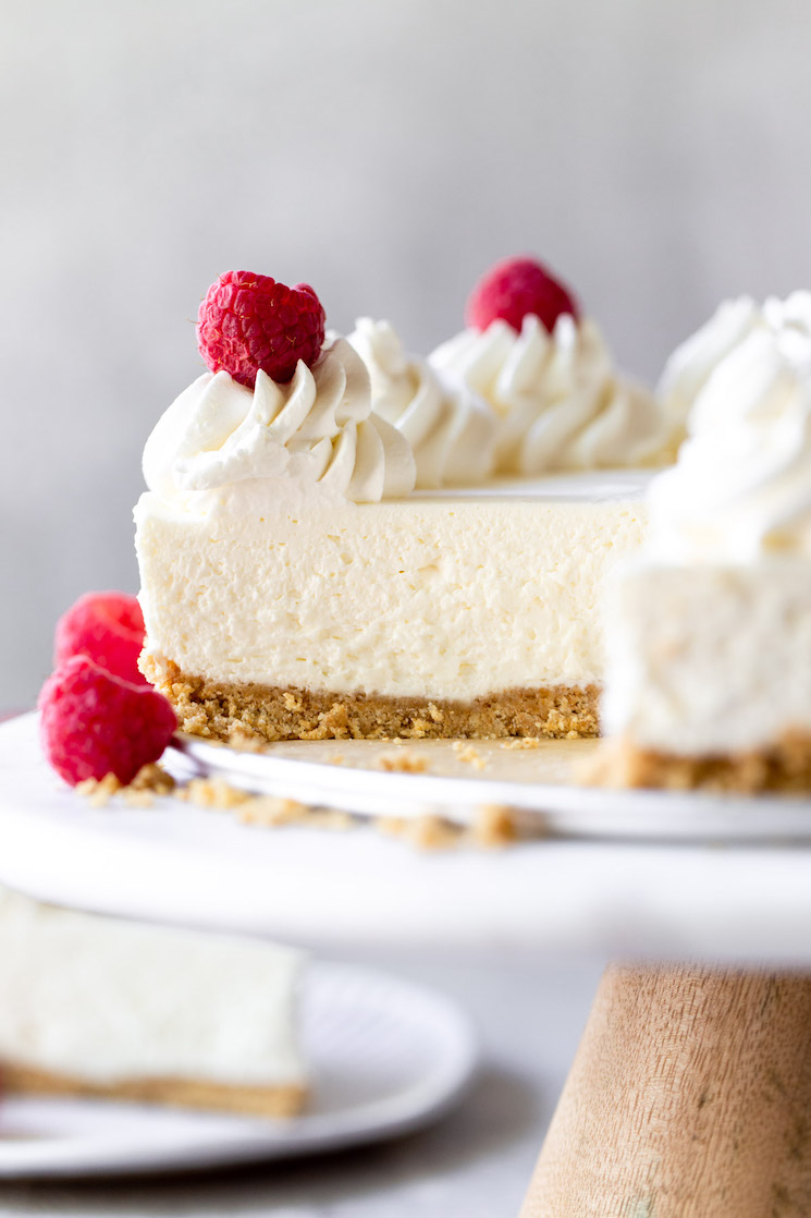 A side view of the no-bake cheesecake with one slice taken out to show the smooth texture of the cheesecake.