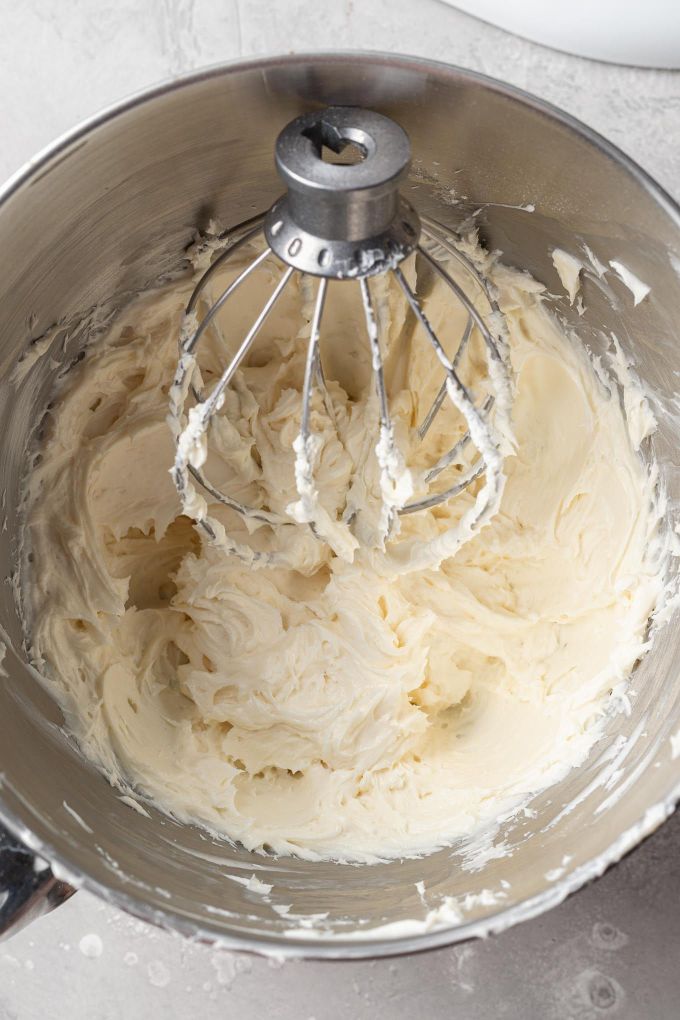 An overhead view of no bake cheesecake filling in a mixing bowl.