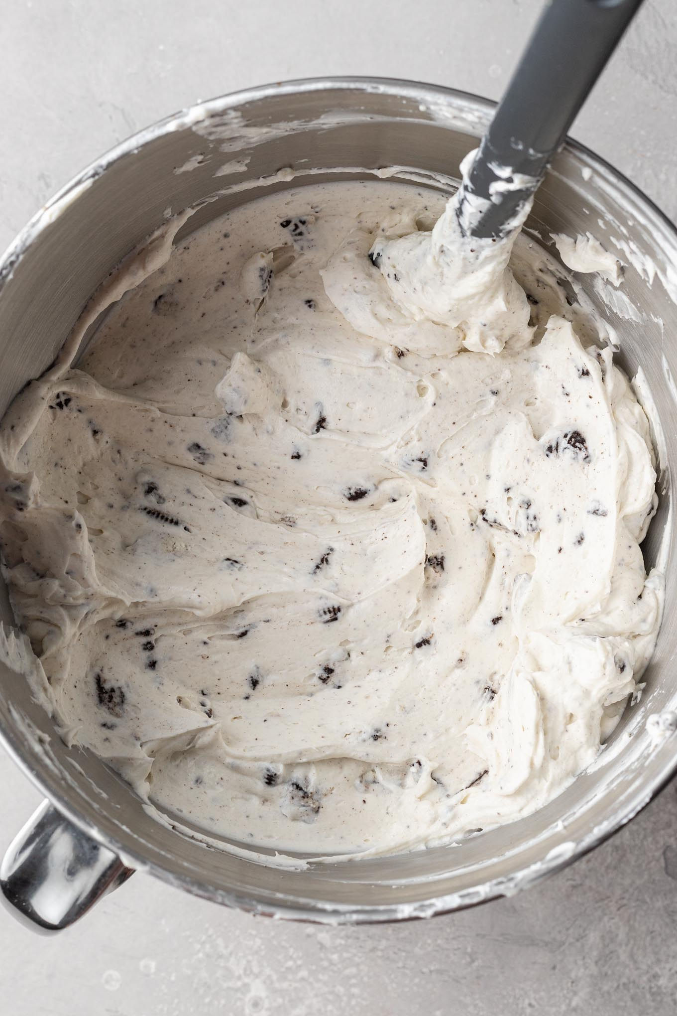 Oreo cheesecake filling in the bowl of a stand mixer.