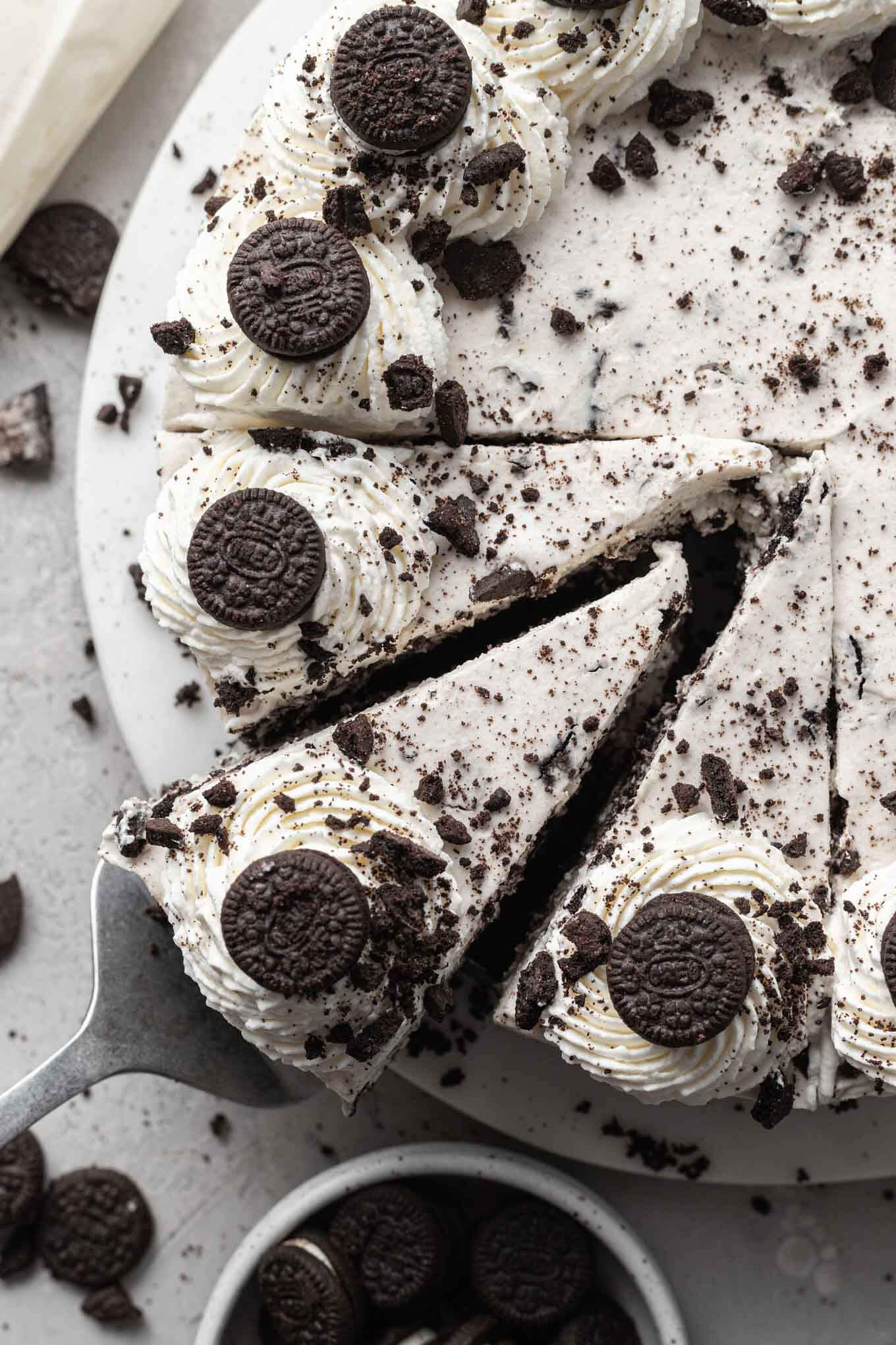 An overhead view of an Oreo cheesecake, with three slices cut out. 