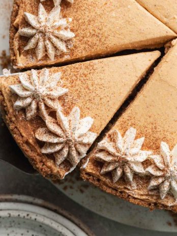 A close-up overhead view of a no-bake pumpkin cheesecake that's been sliced.