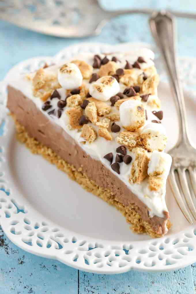 A homemade graham cracker crust topped with a no-bake chocolate cheesecake filling and marshmallow fluff whipped cream. This No-Bake S'mores Cheesecake is the ultimate summer dessert!