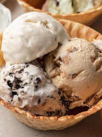 Three scoops of no churn ice cream in a waffle cone bowl.