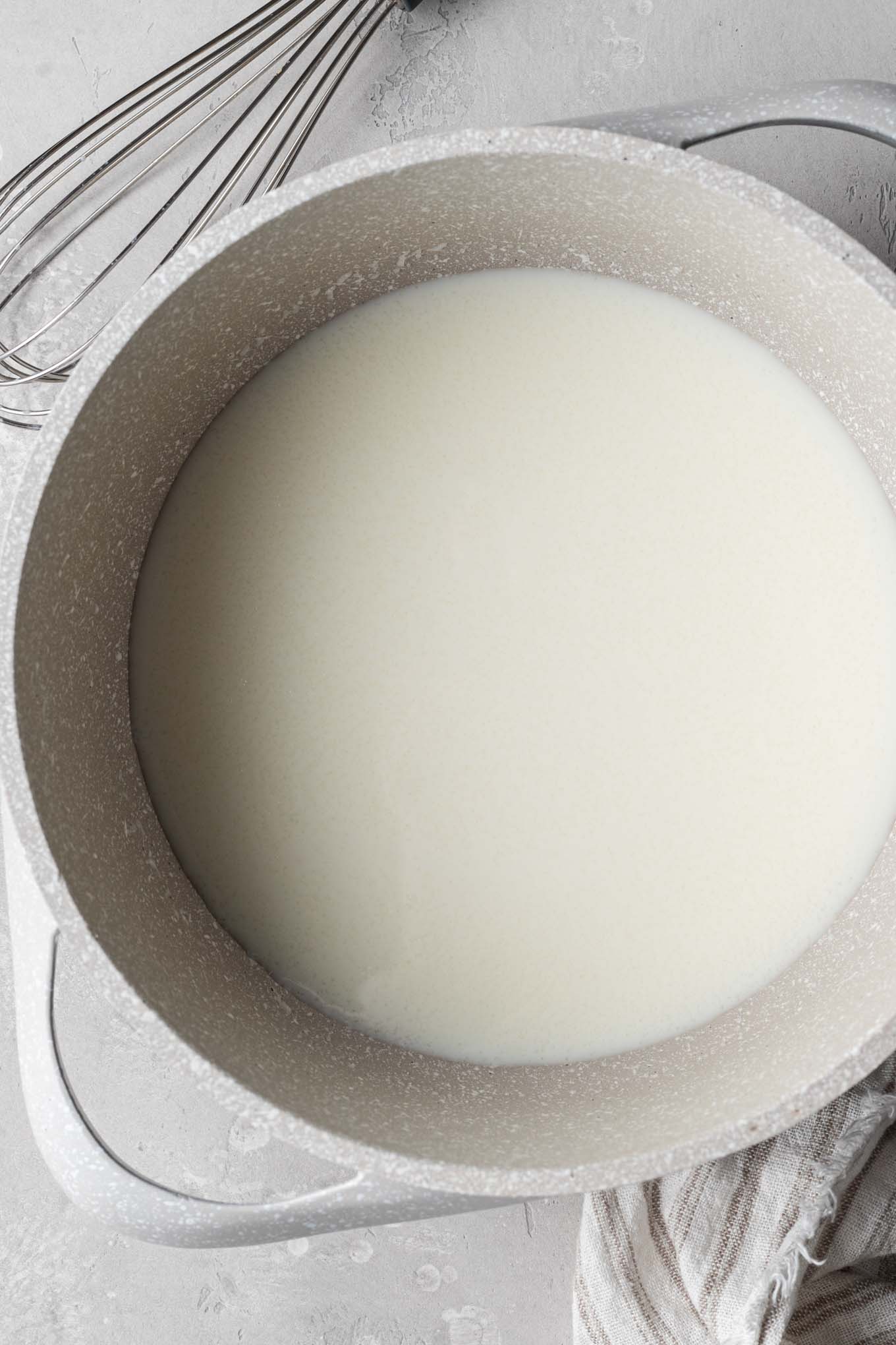 An overhead view of a warm milk and gelatin mixture.
