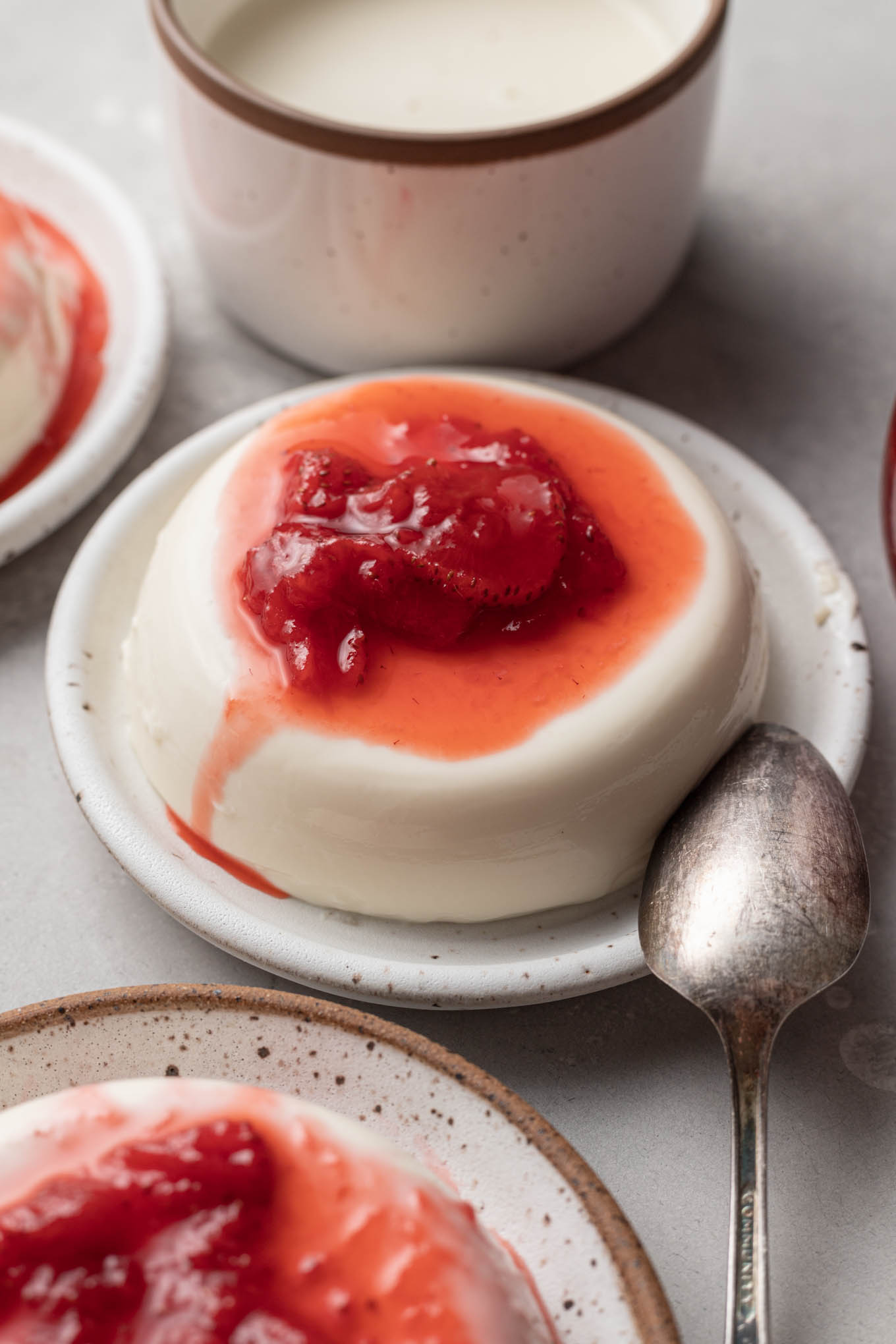 Vanilla panna cotta topped with strawberry sauce. 