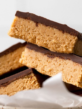 A pile of peanut butter chocolate bars in a speckled dish.