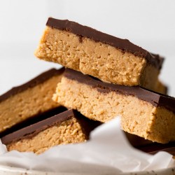 A pile of peanut butter chocolate bars in a speckled dish.