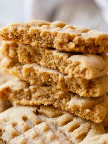 A stack of peanut butter cookies on top of other cookies.