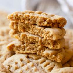A stack of peanut butter cookies on top of other cookies.