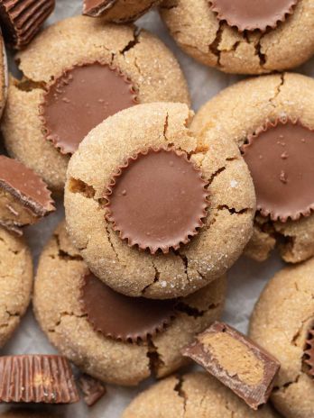 Several peanut butter cup cookies on a piece of parchment paper.