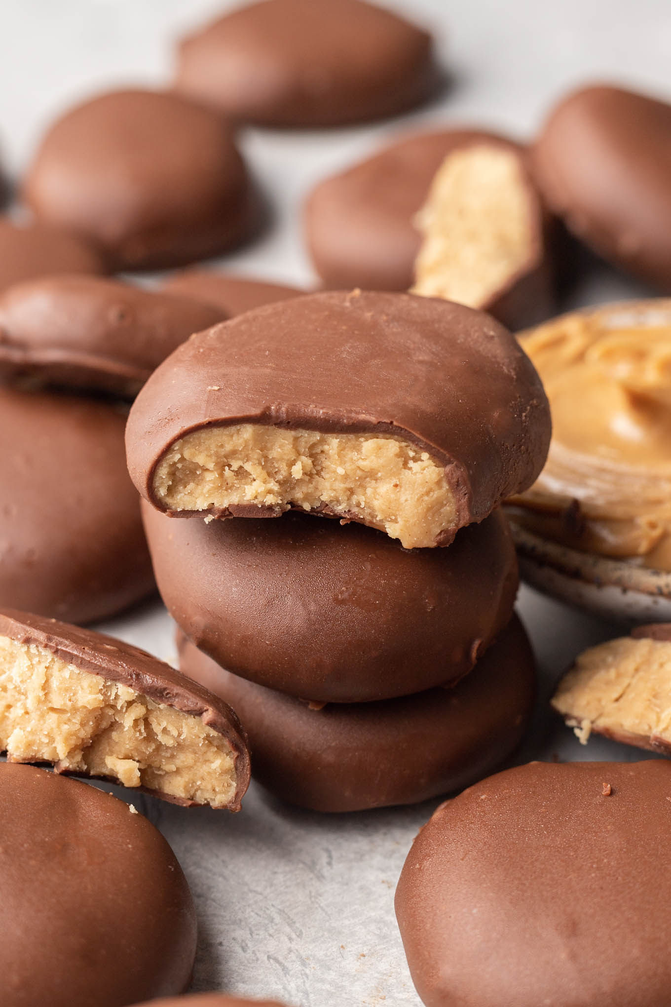 A close-up view of chocolate peanut butter eggs on parchment paper. 