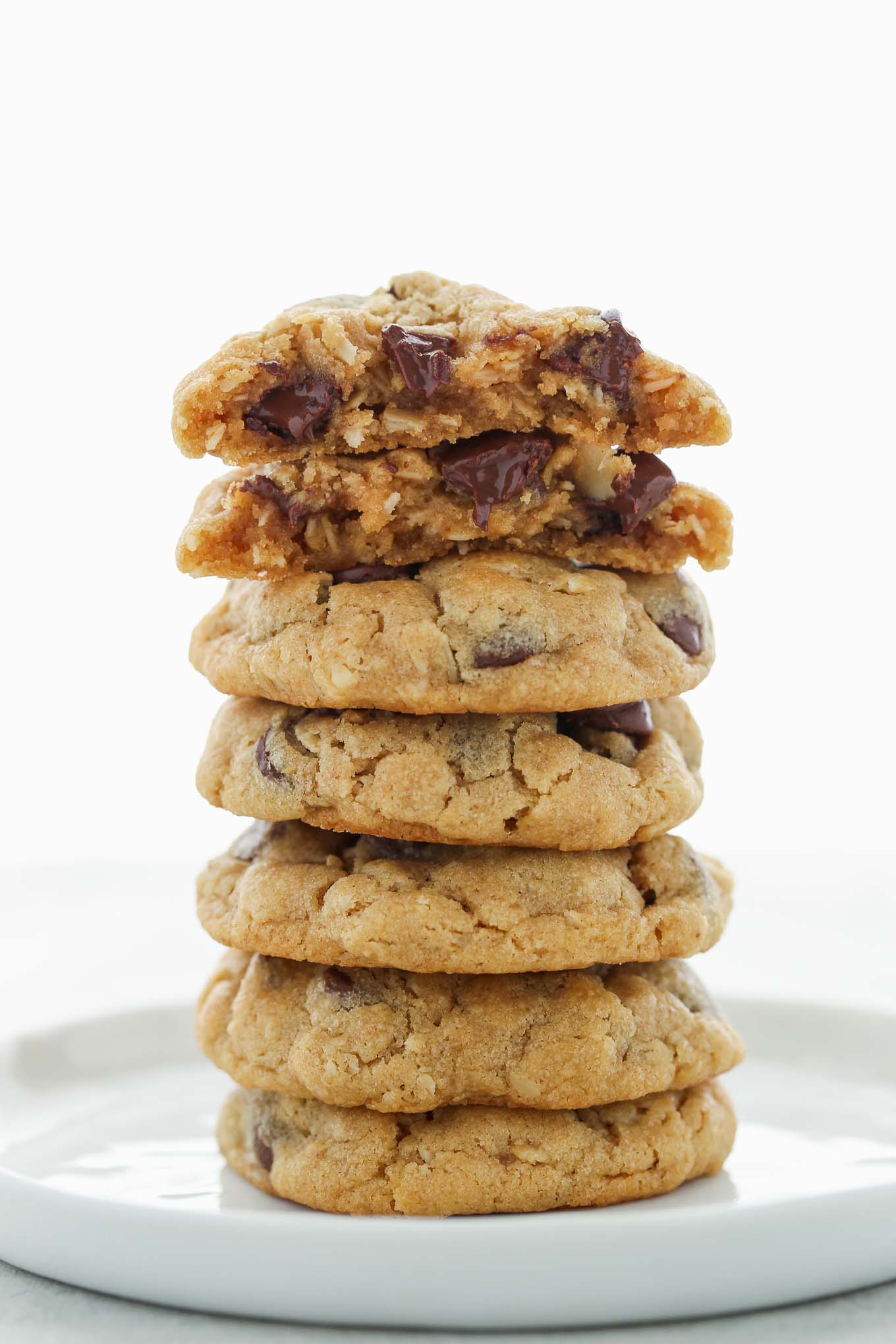 A stack of Peanut Butter Oatmeal Chocolate Chip Cookies on a white plate.