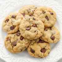 A stack of peanut butter oatmeal chocolate chip cookies on a plate.