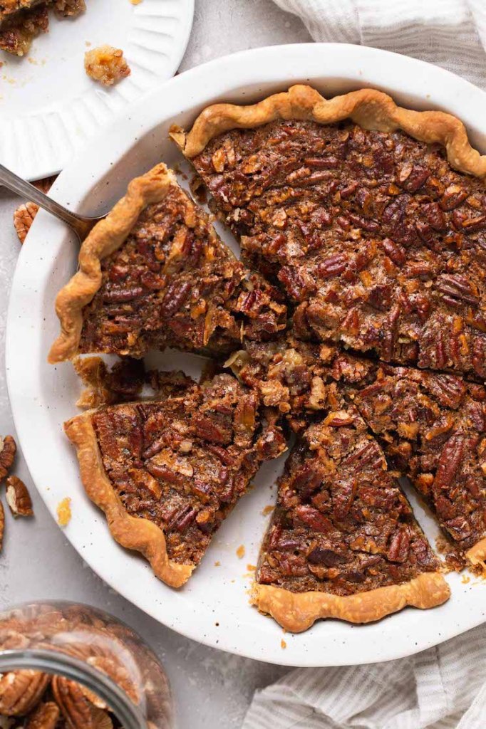 An overhead image of a pecan pie that has been sliced.