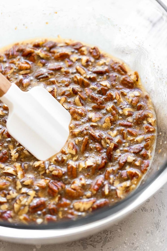 Pecan pie filling in a glass mixing bowl.