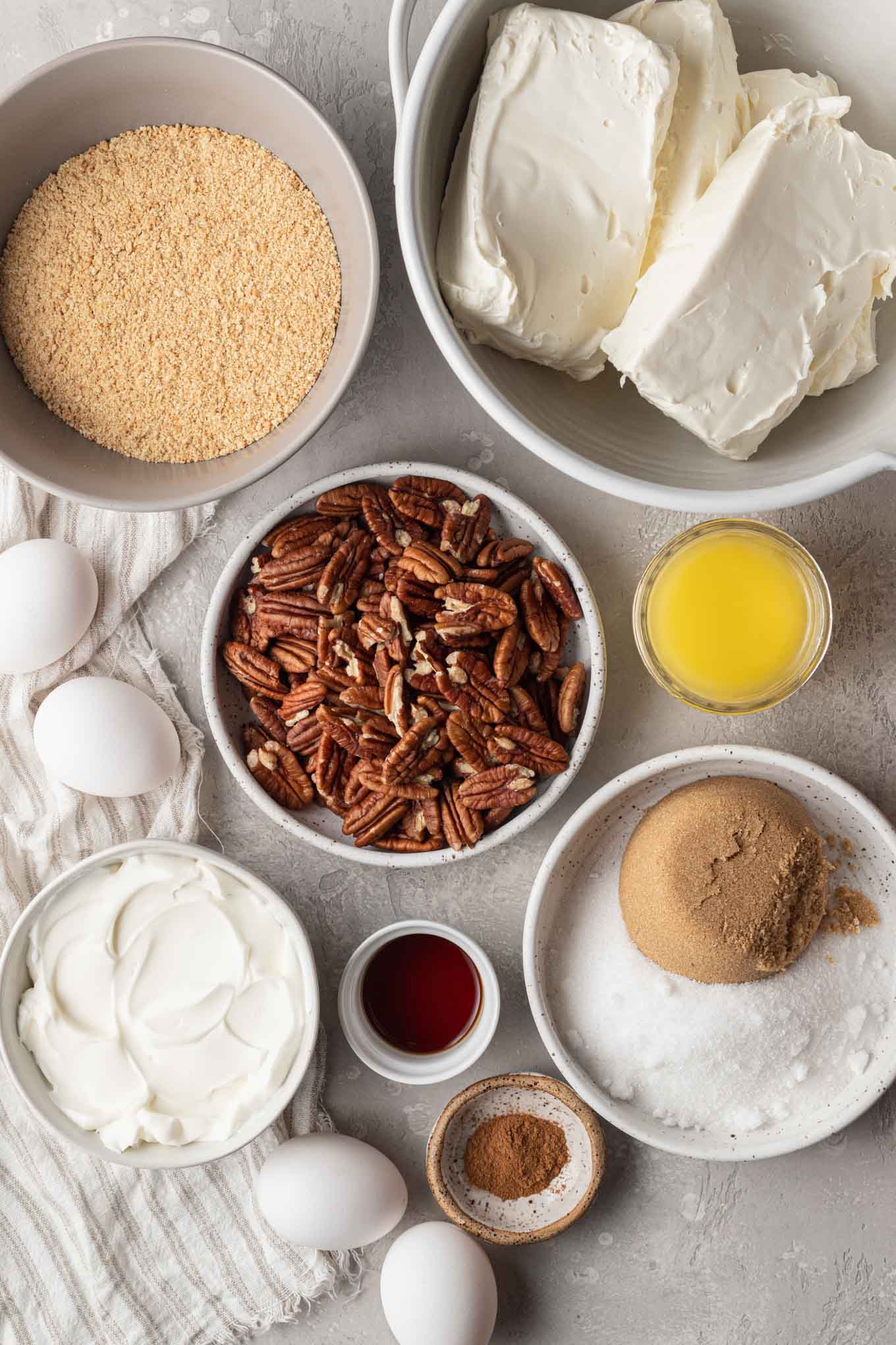 An overhead view of the ingredients needed to make a pecan cheesecake. 
