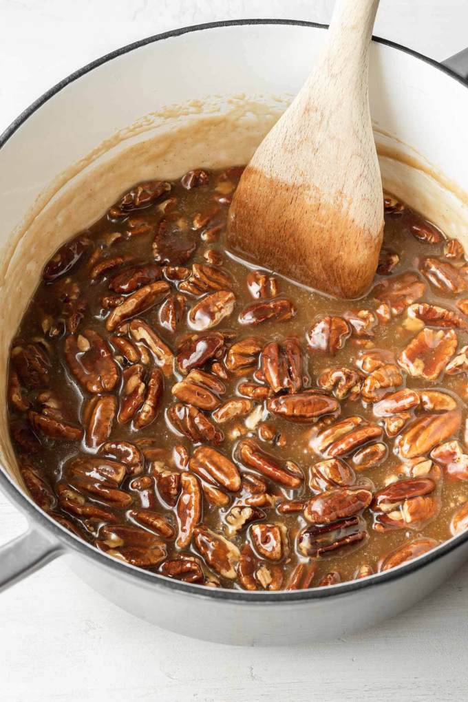 A pot filled with runny praline mixture.