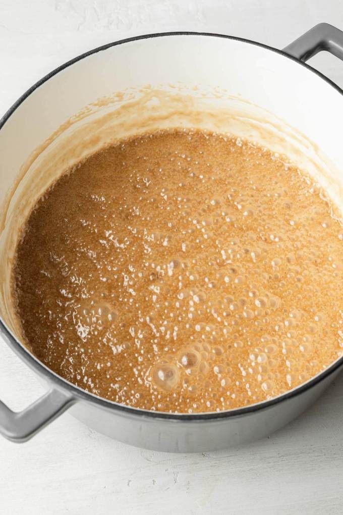 A pot filled with a bubbling butter-sugar mixture.