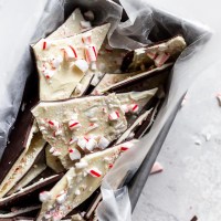 A metal loaf pan with pieces of peppermint bark topped with crushed candy canes.