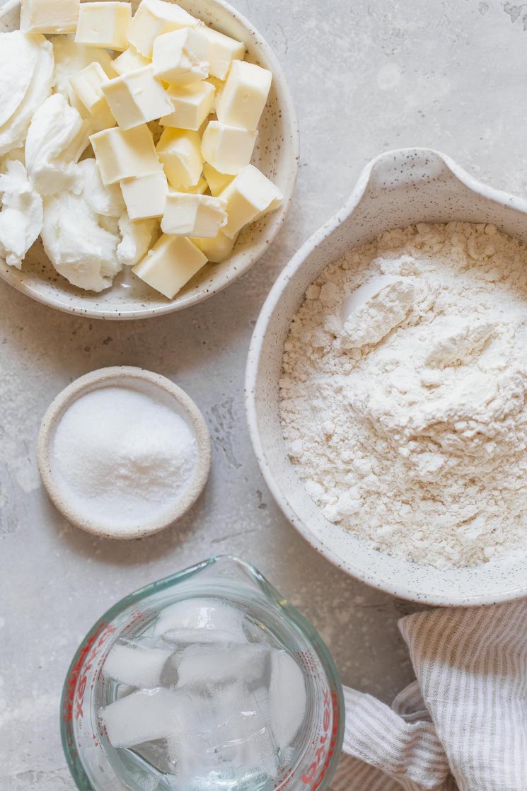 The ingredients needed to make a pie crust in different bowls.