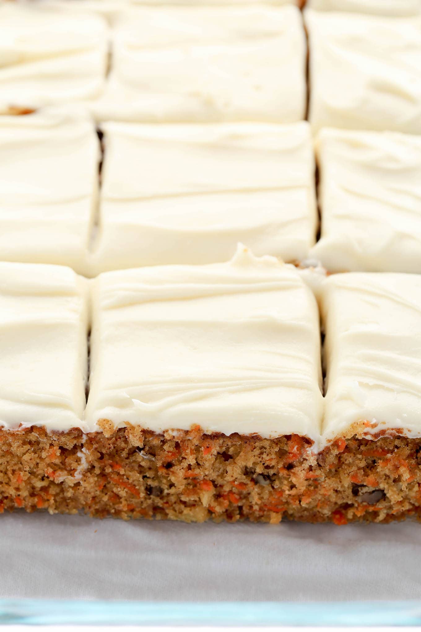 A homemade carrot cake with pineapple, sliced and ready to serve. 