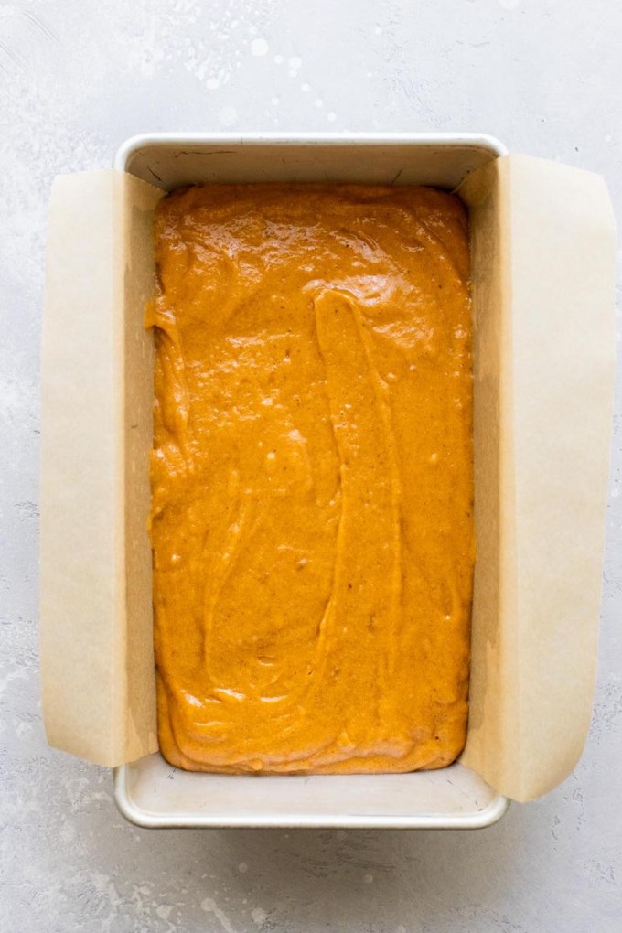 An overhead view of pumpkin bread batter in a loaf pan.