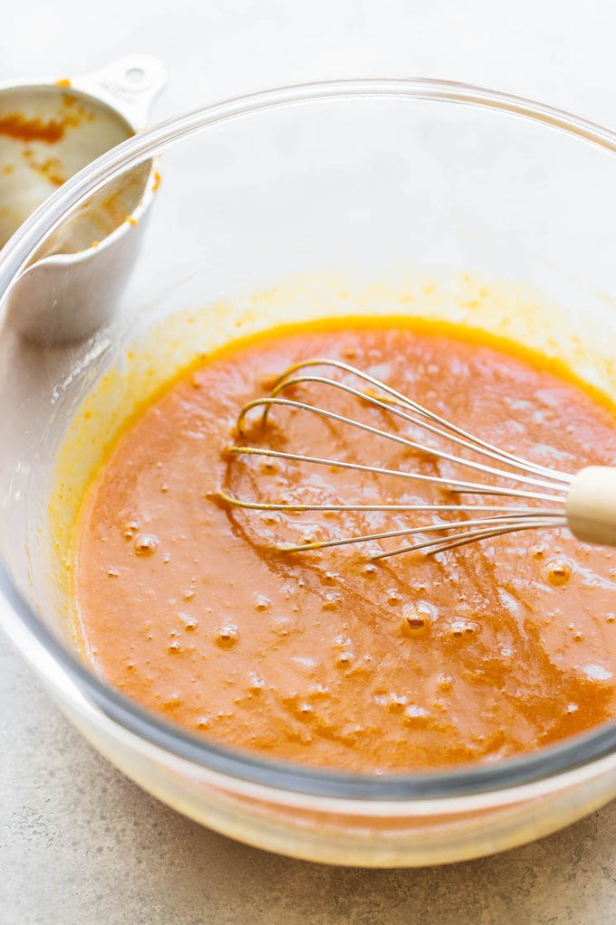 The wet ingredients mixed together in a glass mixing bowl.