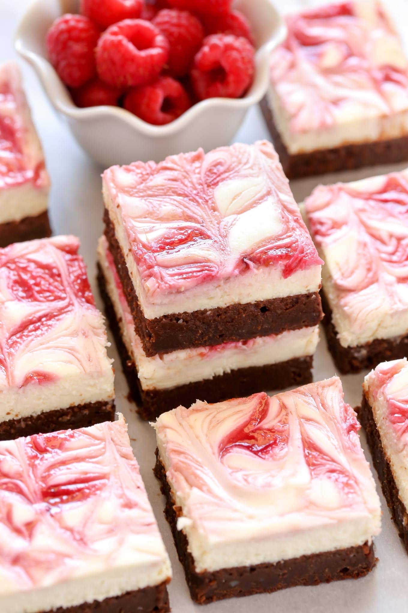 A fudgy brownie base topped with a smooth and creamy cheesecake layer and a raspberry swirl. These Raspberry Cheesecake Brownies make a beautiful dessert for any occasion!