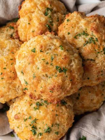 A stack of red lobster biscuits in a bowl lined with a towel.