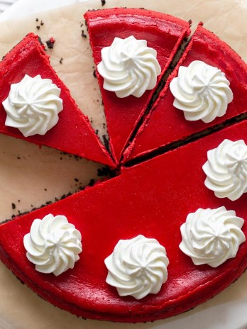 Overhead view of a red velvet Oreo cheesecake that's been partially sliced.