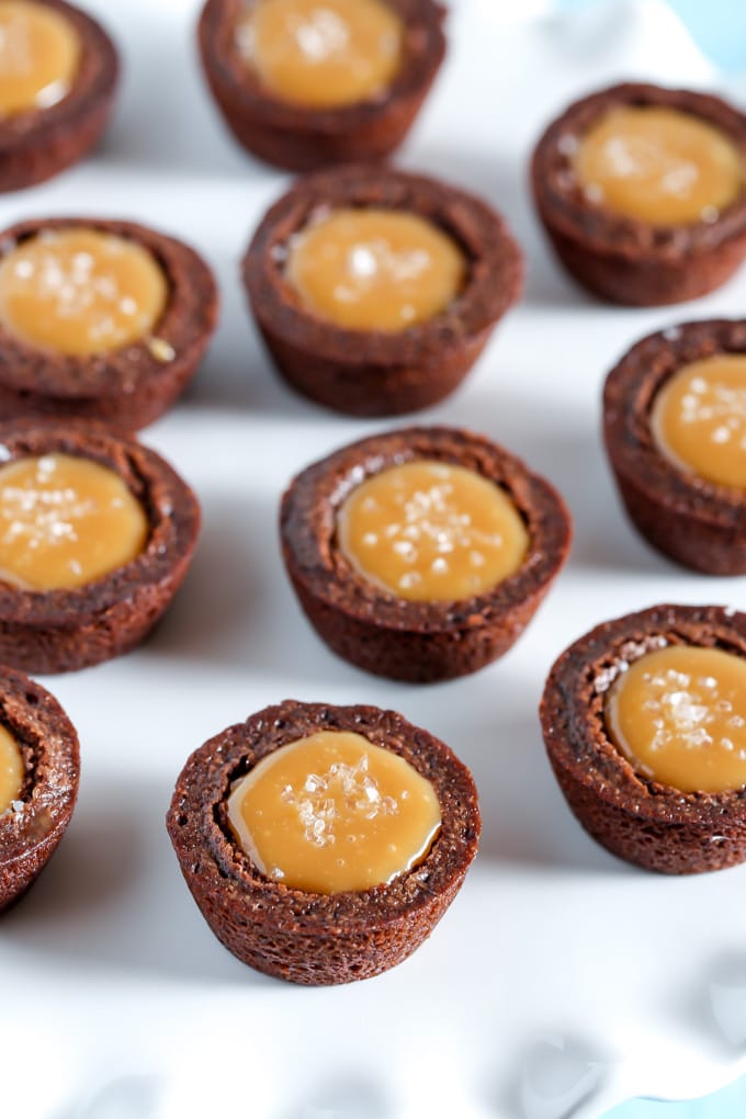 Caramel brownie bites on a white surface. 