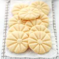 A group of shortbread cookies piled onto an antique safety grater.