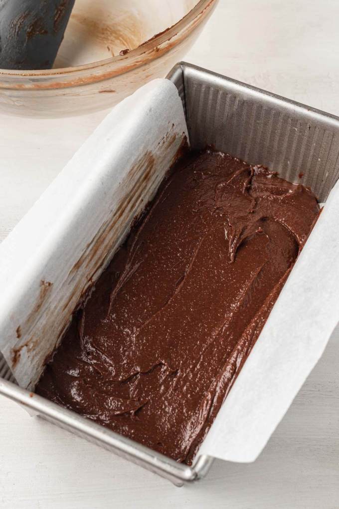 Small batch brownie batter in a parchment paper-lined loaf pan.