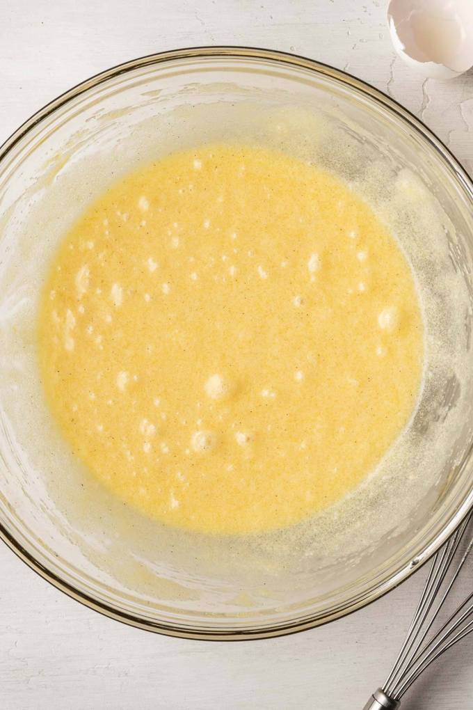 An overhead view of the wet ingredients for small batch brownies in a glass mixing bowl.