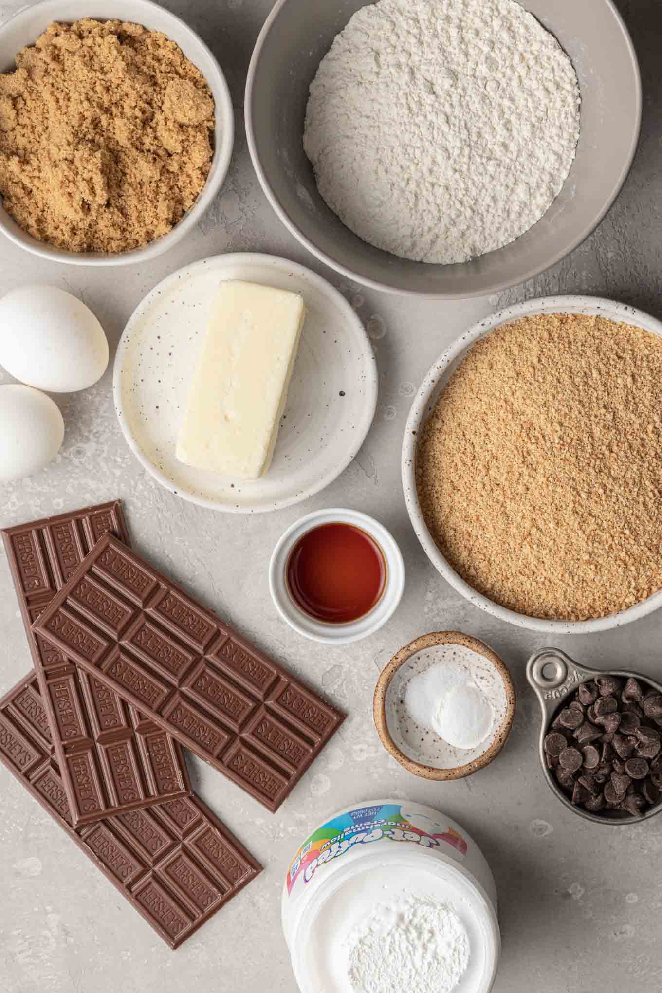 An overhead view of the ingredients needed to make s'mores cookie bars. 