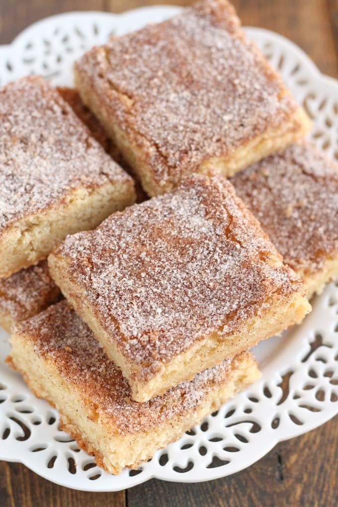 Snickerdoodle bars piled on a white plate. 