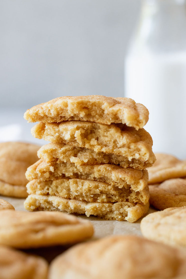 A stack of snickerdoodle cookies broken in half to show the interior texture.